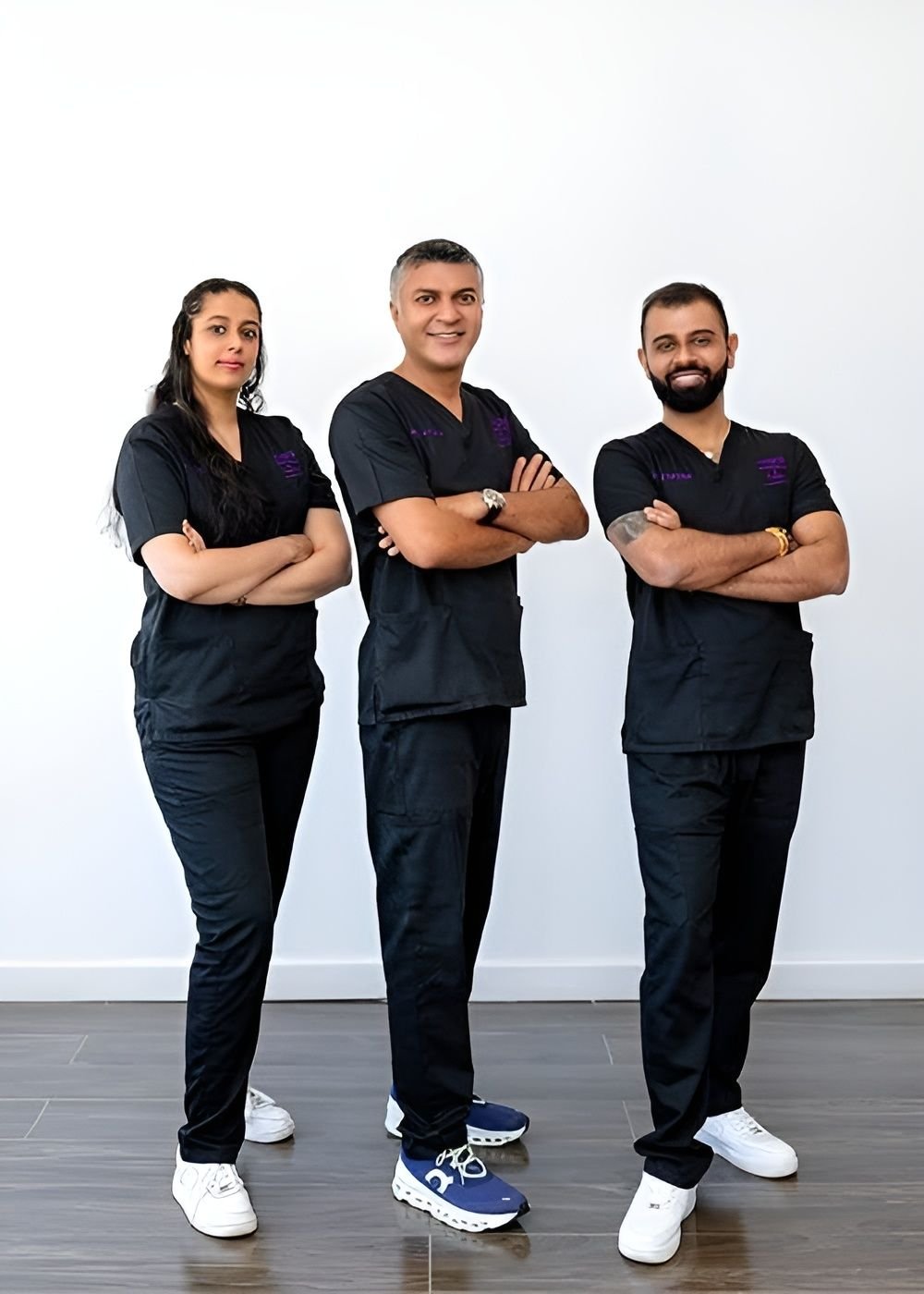 Medical professionals posing together in scrubs.