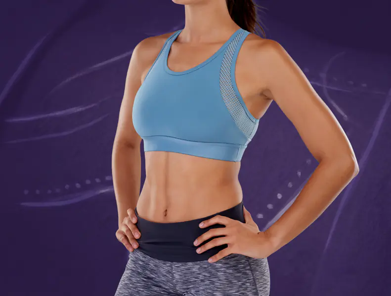 Woman in white bikini posing confidently.