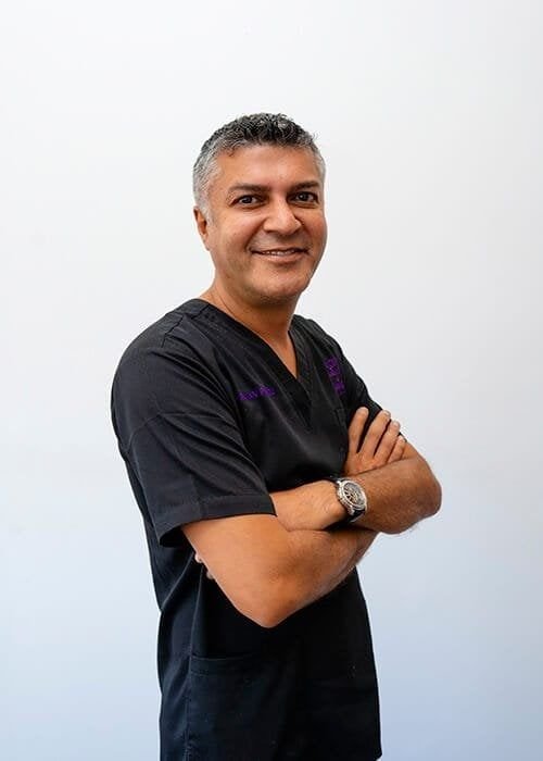 Smiling professional in medical scrubs.