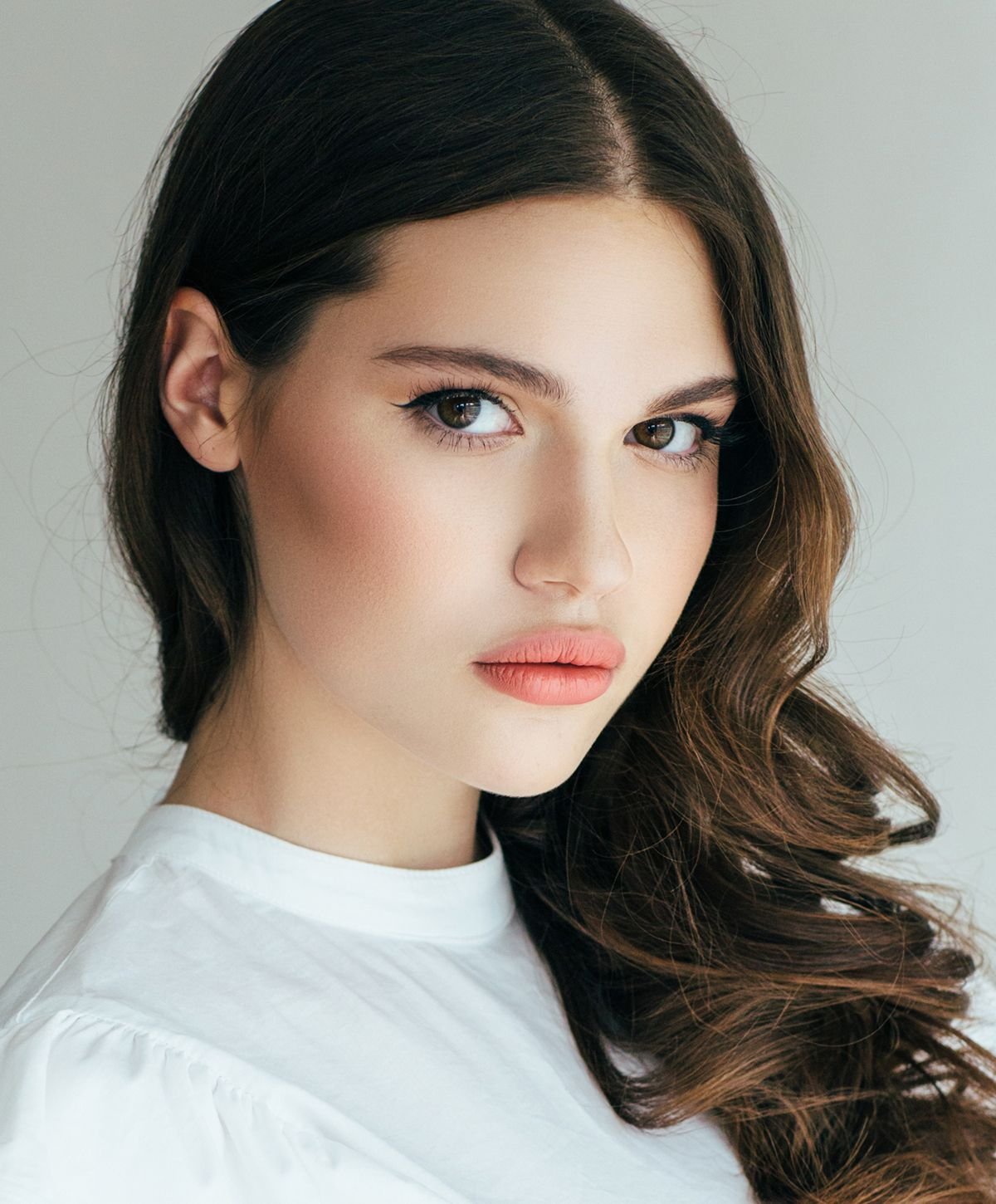 Woman with elegant facial feature staring into the camera.