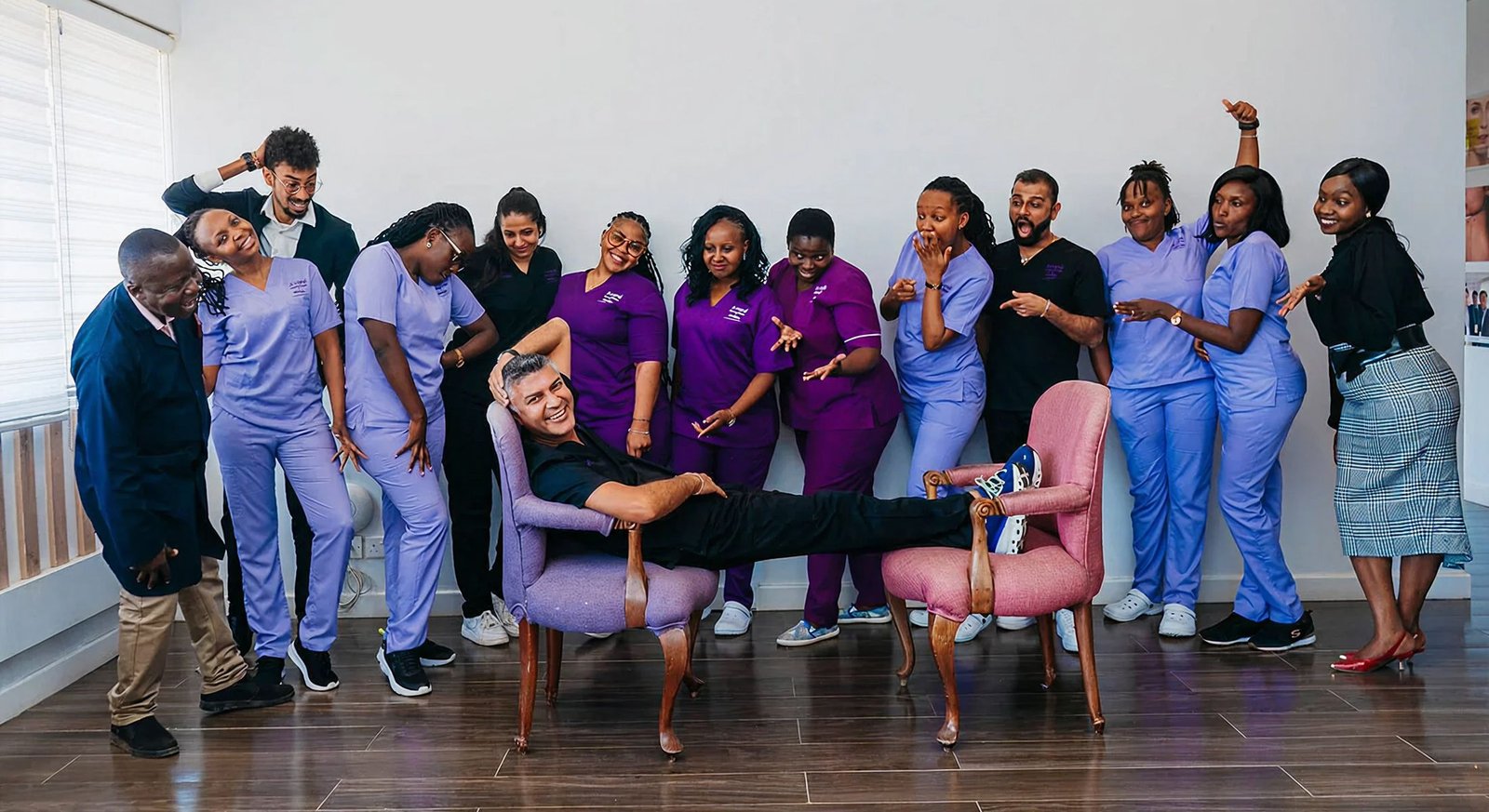 Group of healthcare professionals posing playfully together.
