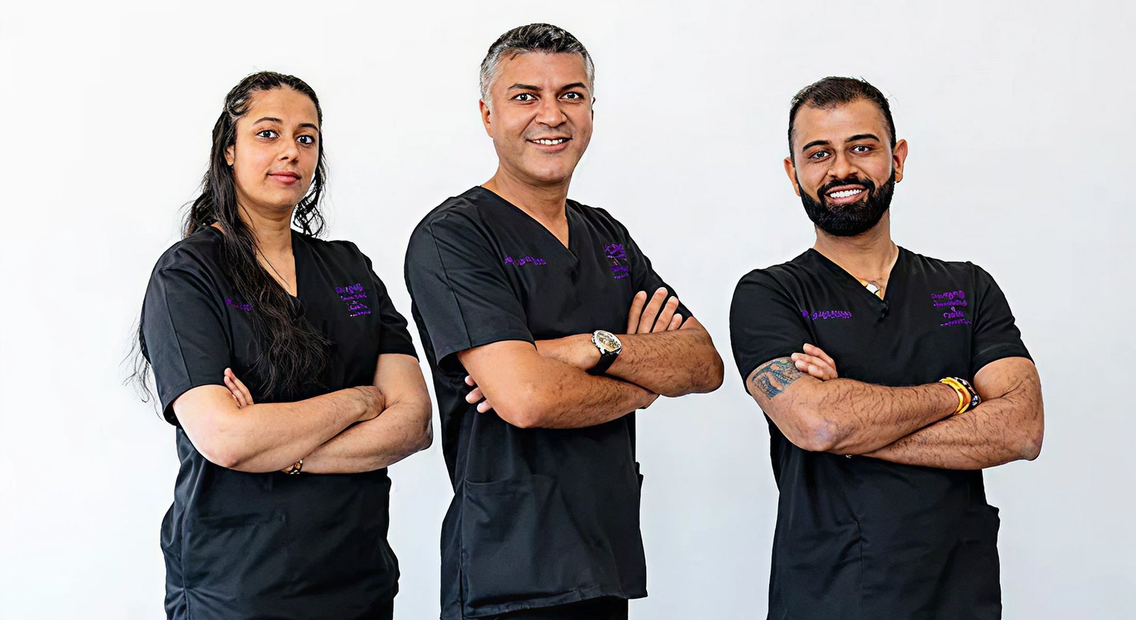 Three medical professionals in black scrubs.
